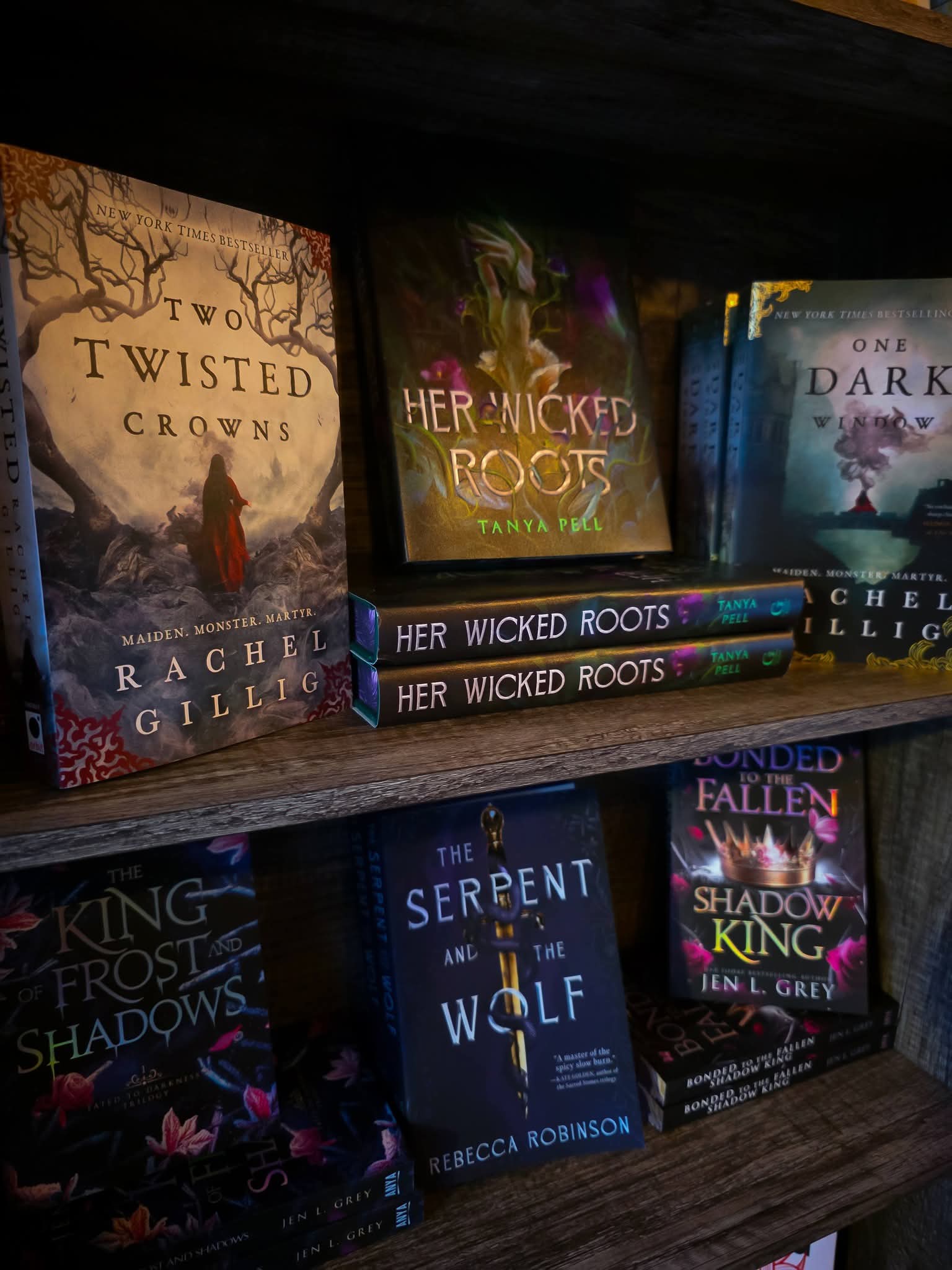 Romantasy and fantasy bestsellers on display — Two Twisted Crowns by Rachel Gillig, Her Wicked Roots by Tanya Pell, One Dark Window, and The Serpent and the Wolf